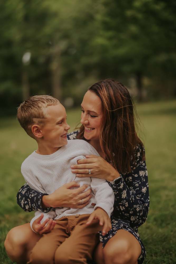 A mother lifting her son into her arms