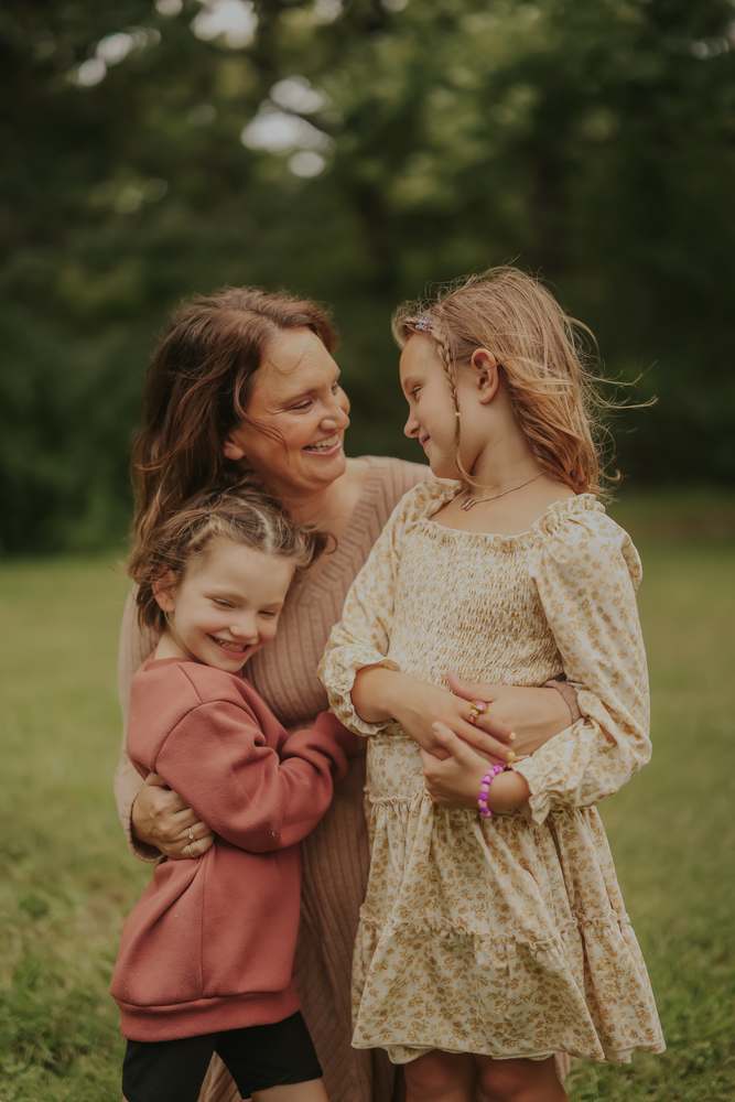 A mother laughing with her two girls
