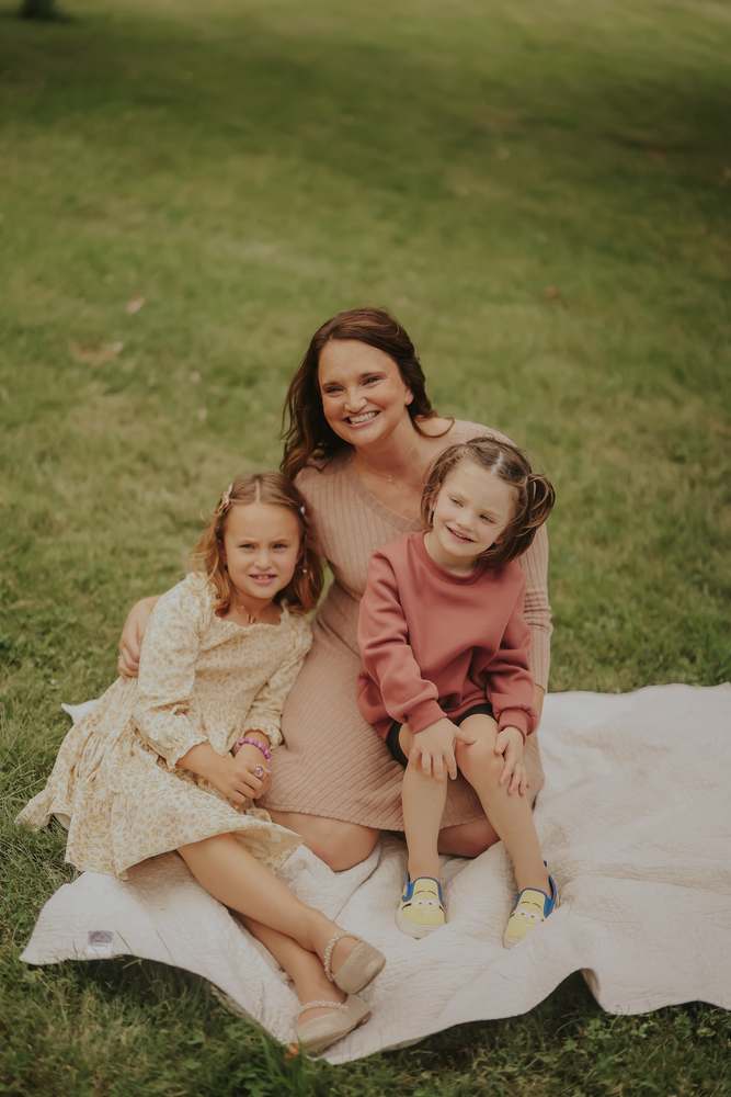 A mother and her girls on the blanket