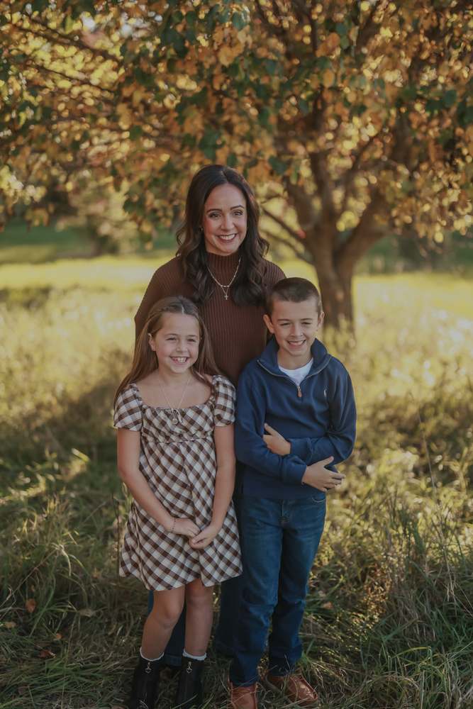 A mother with her son and daughter at golden hour