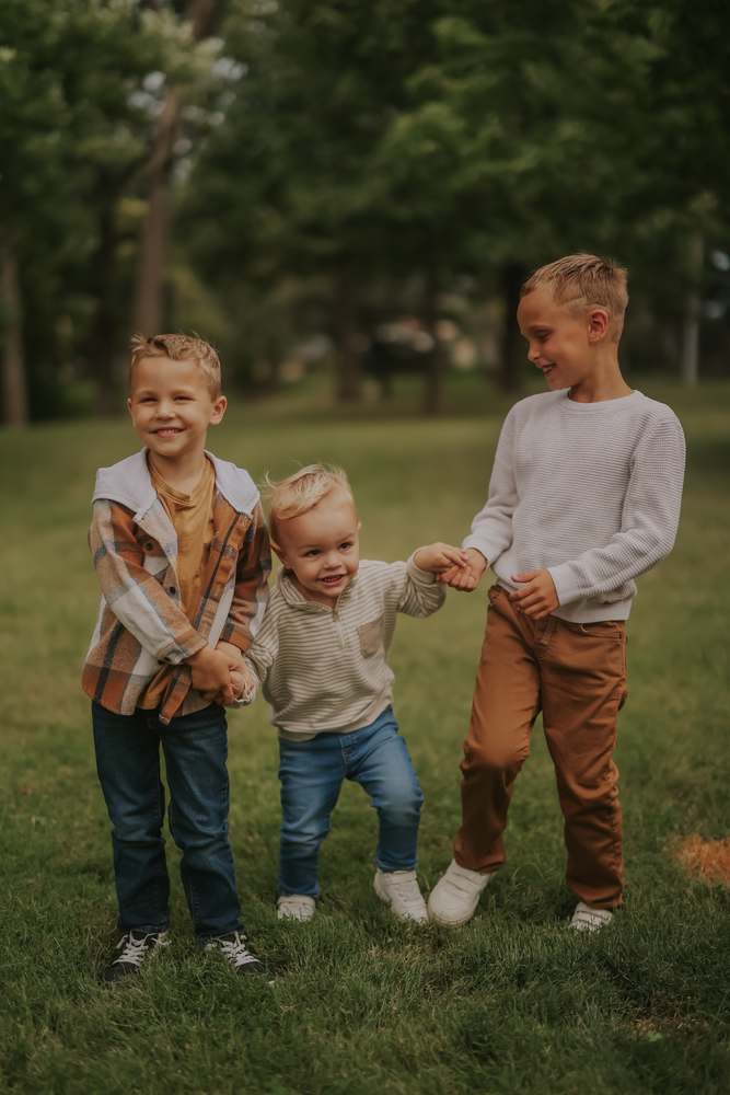 Three brothers holding hands