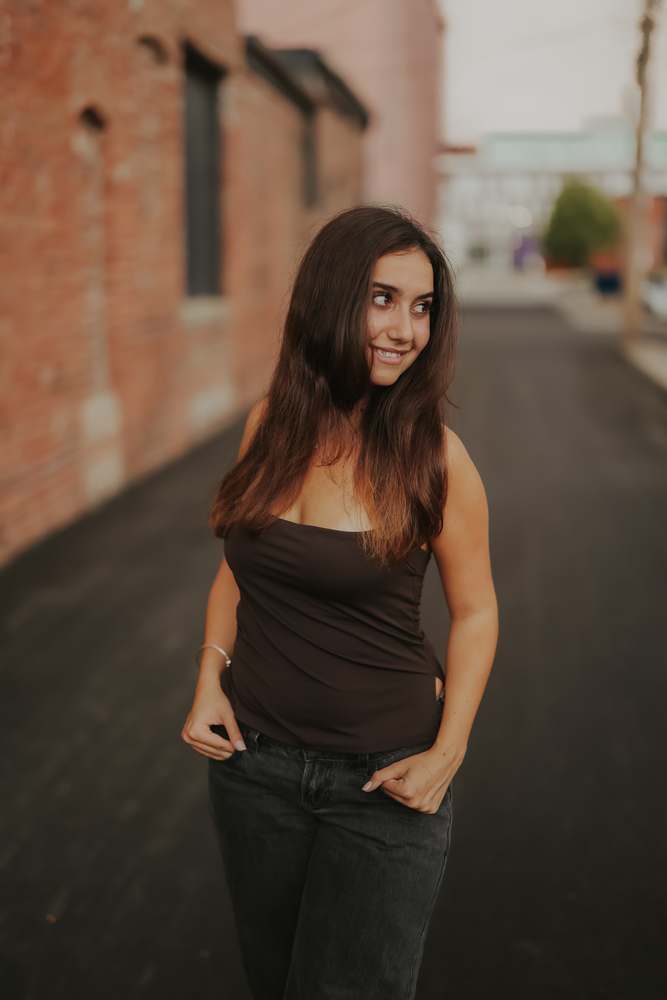 Senior portrait against the brick wall