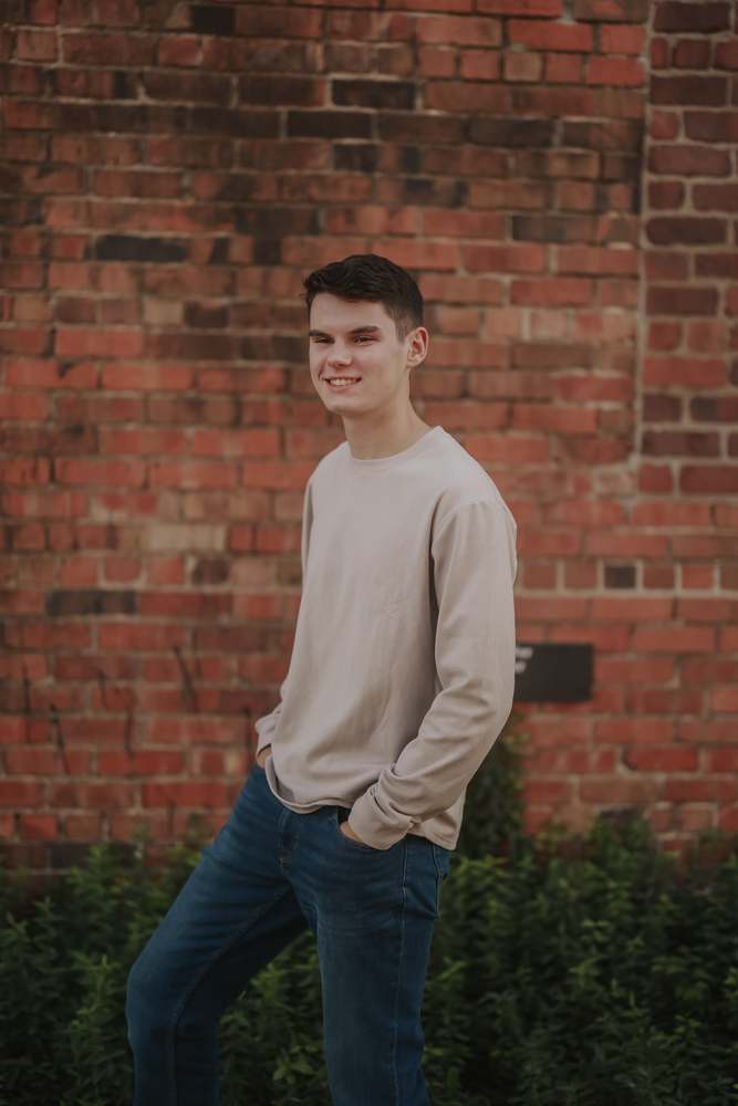 Smiling against the red brick