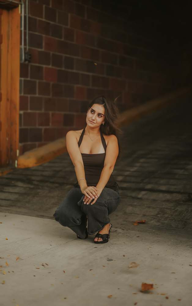 Crouched against the brick wall
