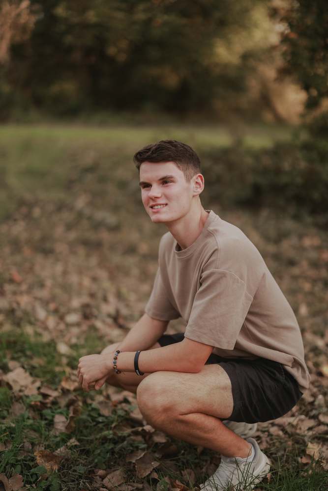 Crouched in the fall leaves
