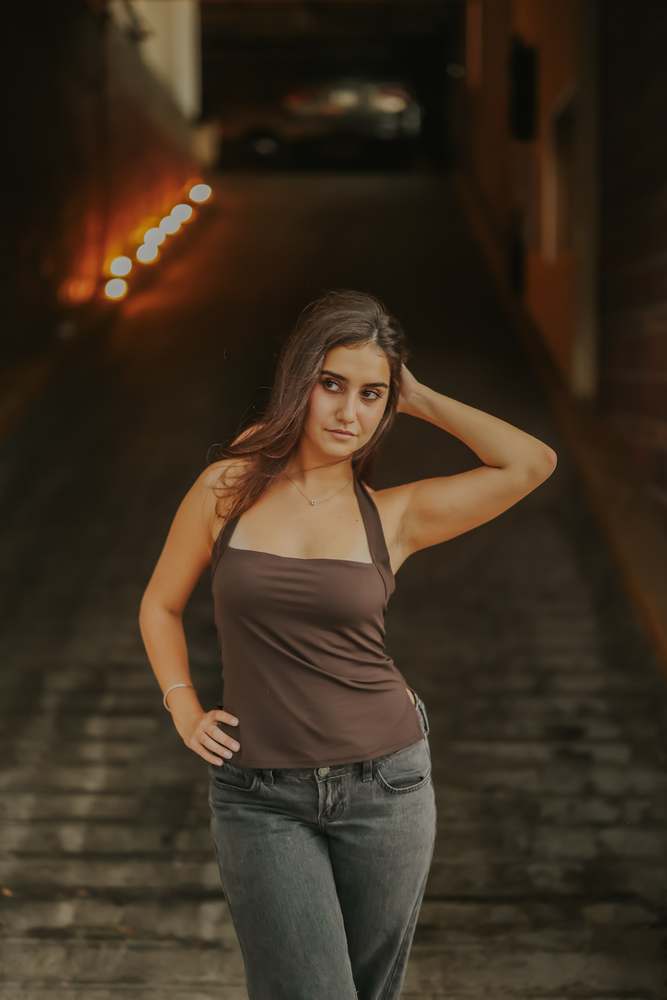 Leaning back against the brick