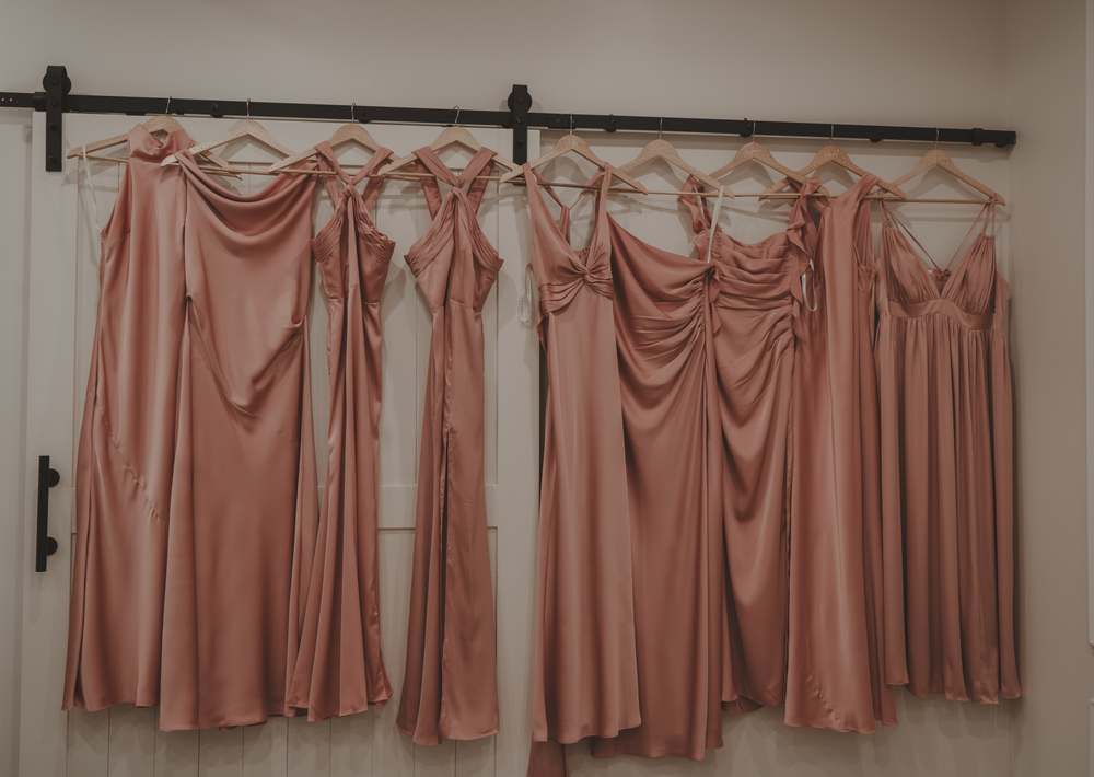A row of blush bridesmaid dresses