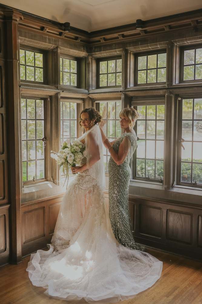 Fastening the gown in the bay window light