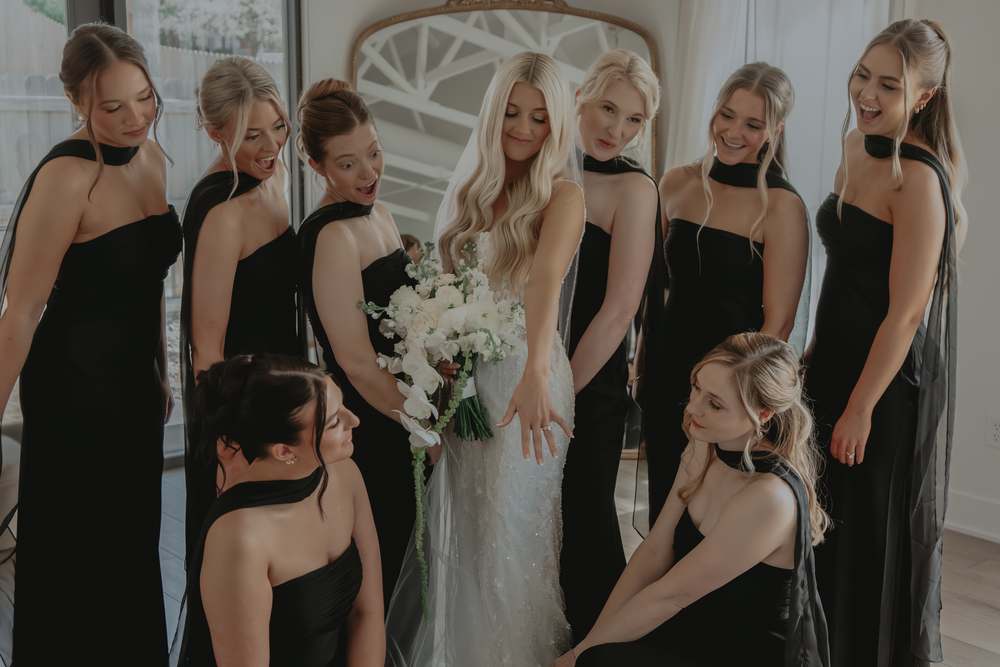 Bridesmaids fussing over the dress before the ceremony