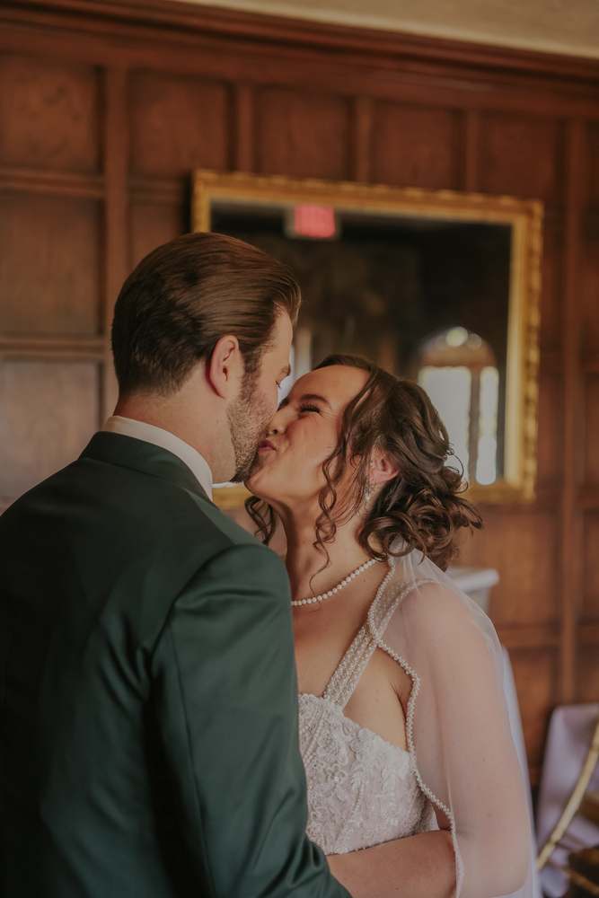 First look kiss in the panelled hall