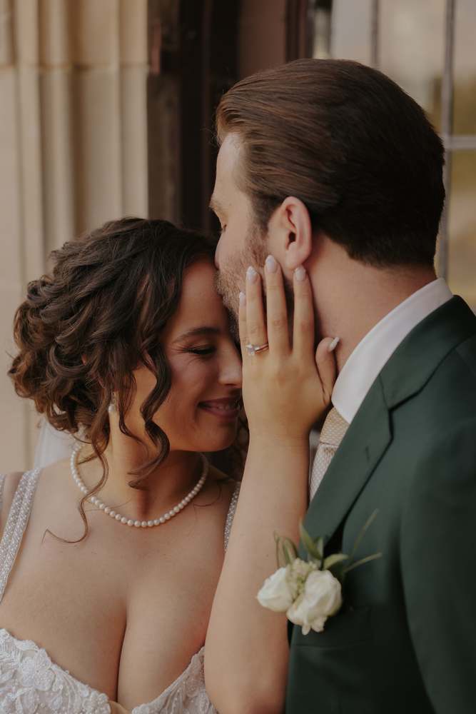 Her hand resting on his face