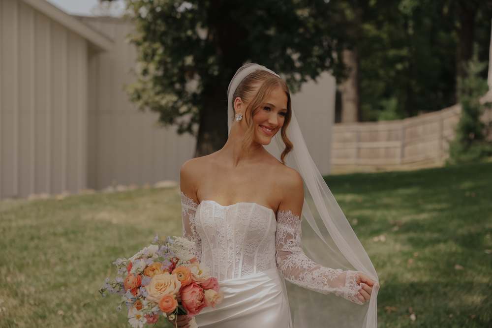 The bride walking with her veil trailing behind