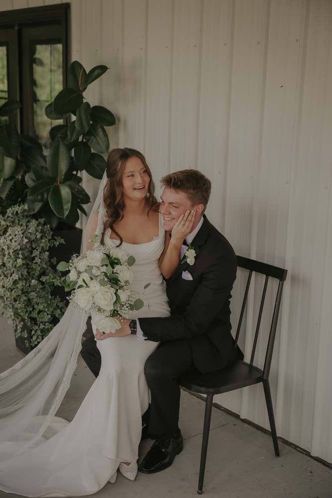Seated together with the veil pooled around them