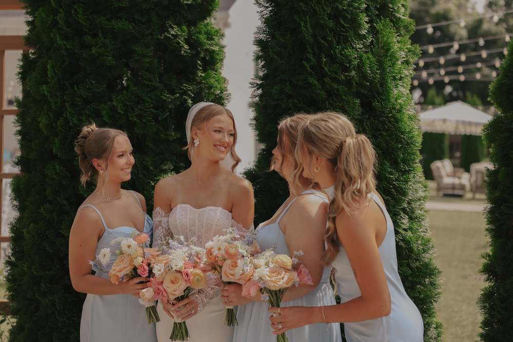 Bridesmaids laughing with their bouquets
