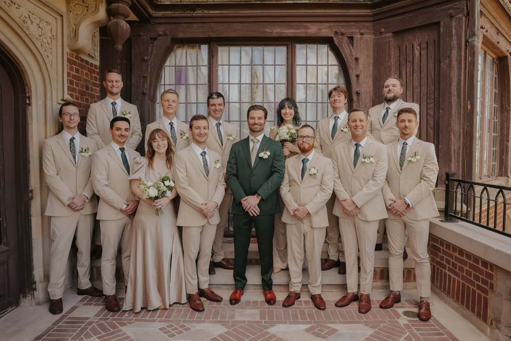 Groomsmen framed by the Tudor staircase
