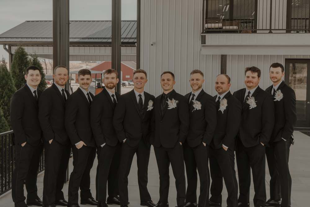 The groomsmen along the venue balcony
