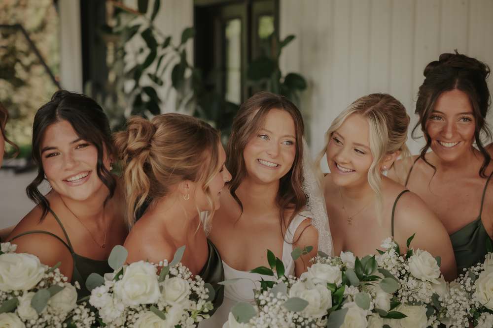 Bridesmaids leaning in together
