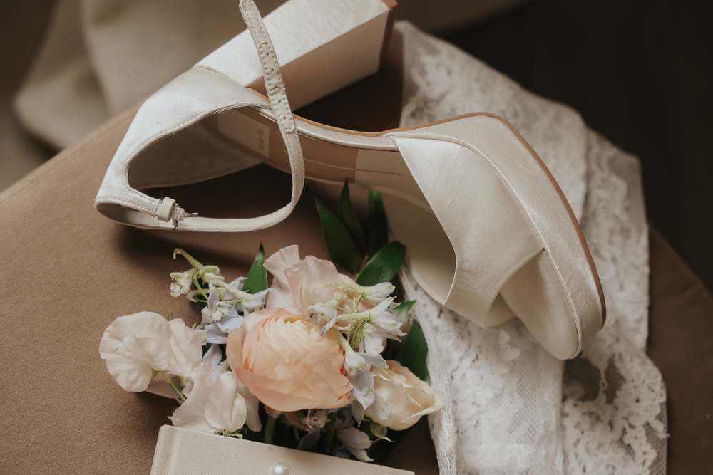 Satin heels beside the dress box