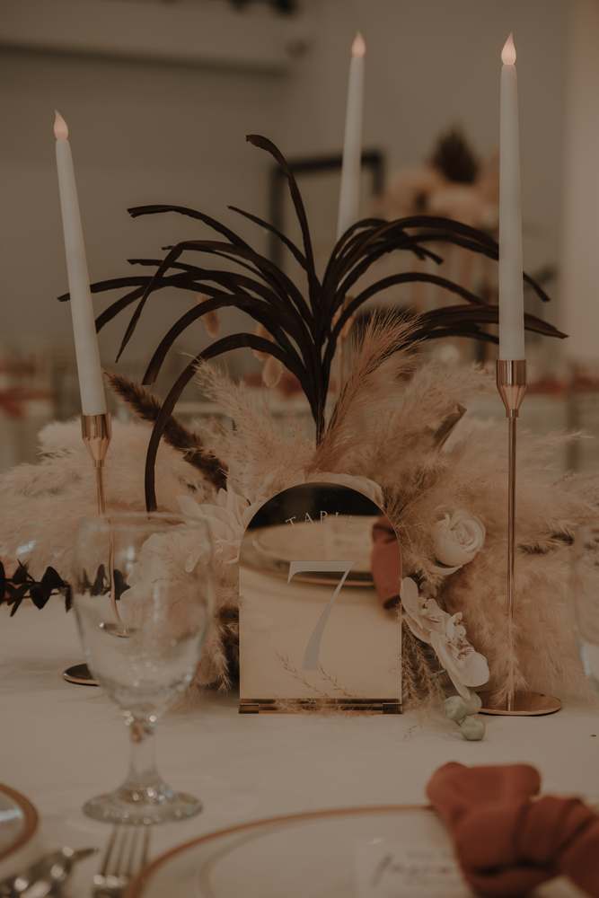 Taper candles and dried florals at the place setting